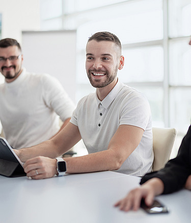 A picture of a BIM team sitting at a table in the office
